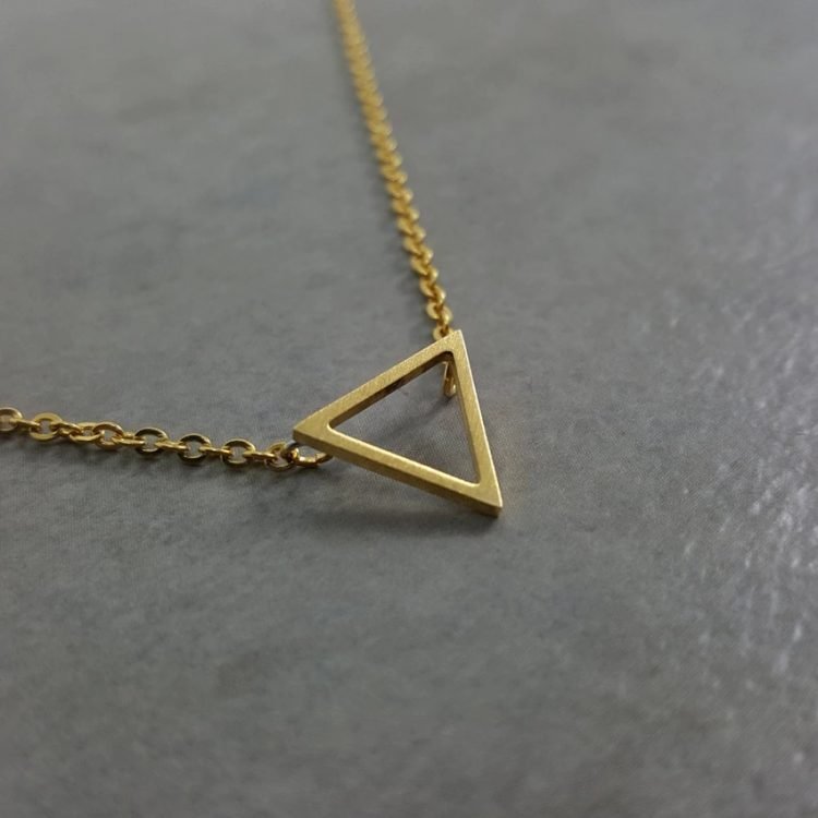 gold color simplistic necklace with minimalism triangle pura vida geometry